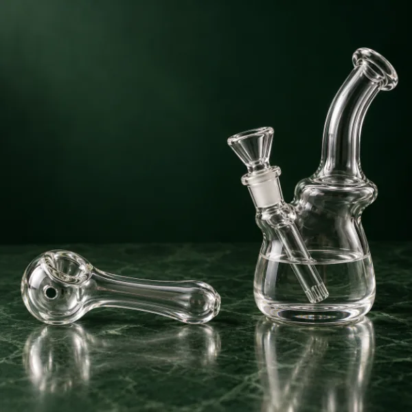 Glass hand pipe next to a glass bubbler for comparison